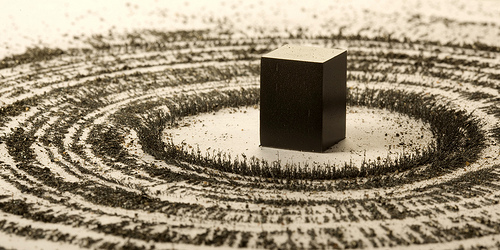 magnet and metal filings representing the Kaaba and pilgrims by artist Ahmed Mater